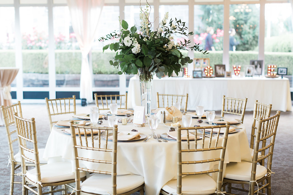 Tall Foliage centerpieces scattered throughout the reception.